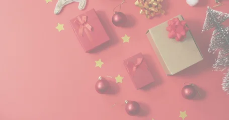 Fotobehang Vlees Displaying medium kraft cardboard gift box with red bow on red tabletop, plus baubles, copy space  © vectorfusionart