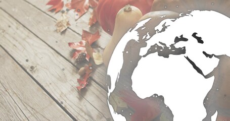 Overlaying globe graphic halftoning Europe Africa over wooden tabletop with pumpkins squash leaves © vectorfusionart