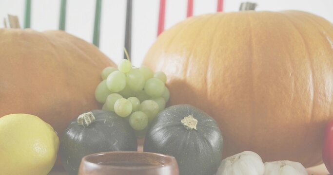 Fototapeta Displaying autumn produce sitting on tabletop, showing pumpkins, grapes, squashes, lemon, garlic