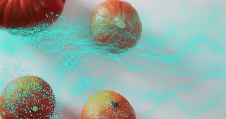 Fototapeta premium Showing four whole oranges sitting on studio tabletop, displaying cyan teal particle cloud and mesh