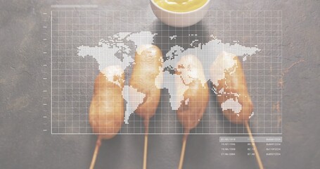 Showing four battered corn dogs on skewers on studio tabletop, with mustard bowl and map overlay
