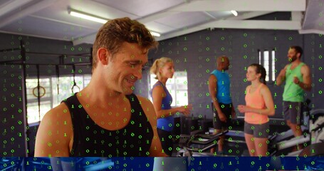 Smiling man in black tank top chatting at gym near rig with rings, green overlay