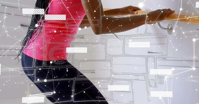 Leaning woman holding wooden barre in studio, with digital overlay, in pink tank and black leggings - Powered by Adobe