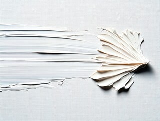 Close-up of white paint strokes on a canvas, arranged to resemble a stylized floral shape, with a minimalist aesthetic and textured background.