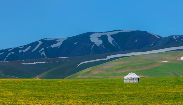 A traditional solitary white yurt on a hillside in the foothills of the Zailiyskiy Alatau near Almaty (Kazakhstan)