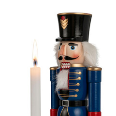 Traditional Wooden Nutcracker Figure Standing Beside a Lit Candle christmas soldier