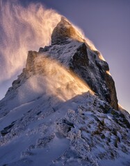 Majestic Mountain Peak with Snow and Wind at Sunset in Winter