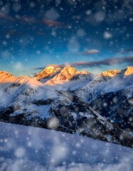 Majestic Snow-Covered Mountains Under Bright Sunset and Falling Snow
