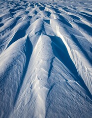 Rippled Snow Surface with Texture and Shadows in Winter Landscape