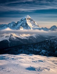 Stunning Snow-Capped Mountain Peak Under Blue Sky at Sunrise