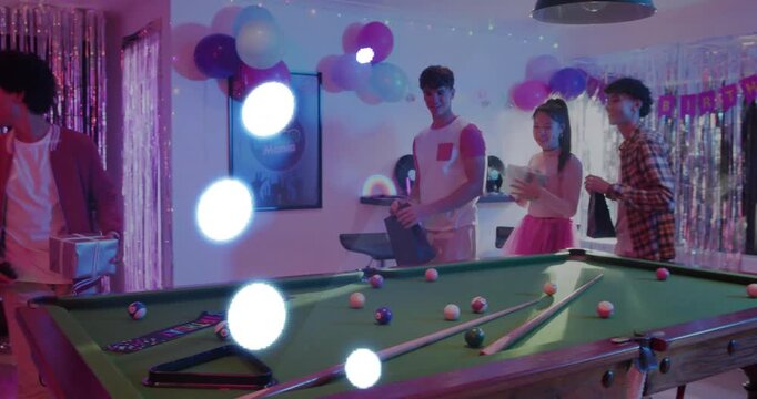 Group entering holding gifts and plates passing items across pool table with animated party lights