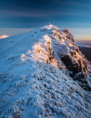 Snowy Mountain Peak During Sunrise with Dramatic Sky and Clouds