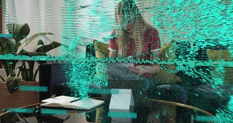 Woman sitting on sofa sorting tech docs and using tablet, causing teal data globe sweeping forward - Powered by Adobe