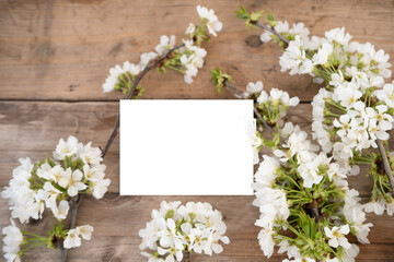 Springtime floral arrangement with Blooming cherry branches on natural wood texture, Spring floral background for Easter, Mother's Day, or greeting cards