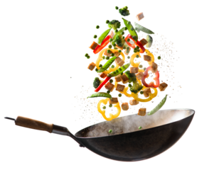 Fresh stir fry vegetables being tossed in a wok isolated on transparent background