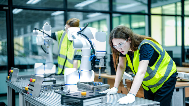 robotics engineer in an R&D lab performs diagnostics on an AI-driven collaborative robot (cobot). She is inspecting the hardware and system sensors.
