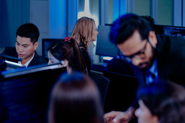 High-energy tech team collaborates late night. A manager provides rapid guidance, driving project progress in a bustling, modern office hub pulsing with deadline-driven synergy.