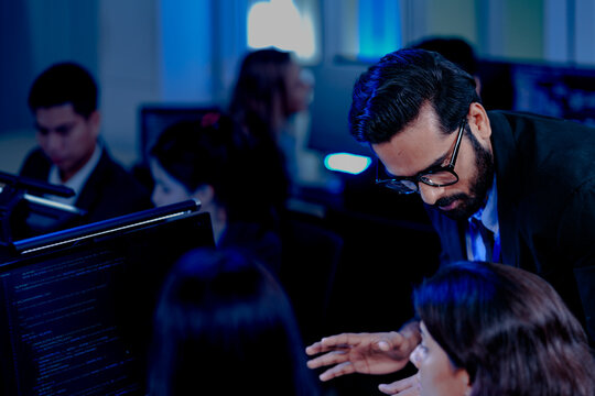 Data-driven deep dive: Analysts side-by-side, immersed in complex datasets across multiple screens. Monitoring real-time analytics or training machine learning models late night.