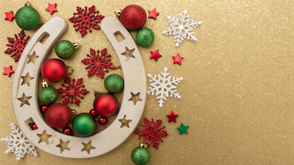 Brightly colored holiday decorations combine with a wooden horseshoe for a festive Christmas atmosphere during the holiday season