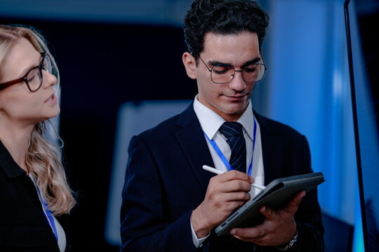 Unveiling the future. Smiling innovator presents a groundbreaking algorithm or quantum code on screen, explaining the next leap in AI or complex computation to his excited team.
