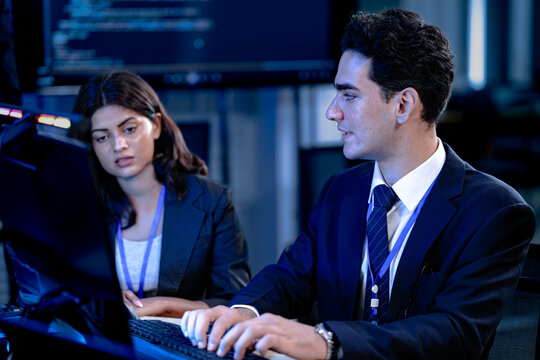 Code compiled success. Smiling developer celebrates breakthrough with team late night coding session solving complex bug collaborative tech win achievement unlocked.