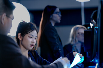 Cyber defenders hold the line late night ops center. Focused diverse analysts track threats multiple screens real time data intelligence crucial vigilance protects vital systems now.