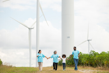 Volunteers are walking behind a windmill farm, volunteer charity people. charity community service event, ngo business and outreach, Group Diverse people meeting at park for donation