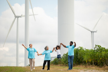 Volunteers are walking behind a windmill farm, volunteer charity people. charity community service event, ngo business and outreach, Group Diverse people meeting at park for donation
