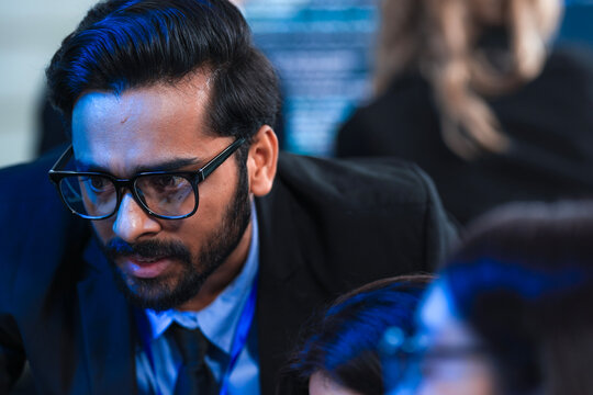 Deep code analysis huddle late night. Senior developer points out intricate logic colleague absorbs critical details screen reflects complex script intense debugging session proceeds now code work.