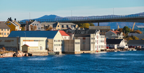 Warehouses and docks along the calm harbor of Kristiansund, Norway