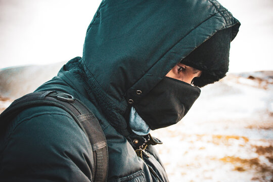 Man in the winter cold black jacket bundled 