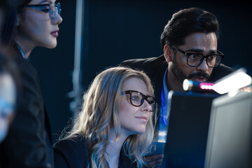 High stakes finance night Diverse analysts track volatile global markets intense focus monitor screens real time data critical decisions hedge fund trading floor pressure on now.