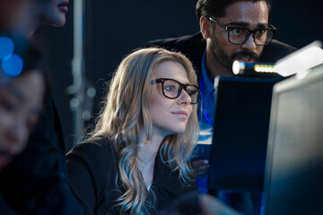 High stakes finance night Diverse analysts track volatile global markets intense focus monitor screens real time data critical decisions hedge fund trading floor.