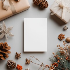Blank Christmas greeting card mockup. Blank white card surrounded by festive Christmas and winter holiday decorations