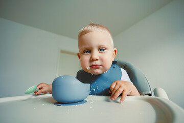 Curious baby explores food with wonder in a bright, modern kitchen during mealtime moments filled with joy and discovery