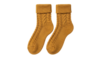 Isolated pair of warm, fashionable mustard-yellow socks with cable pattern, cuff, ribbed trim
