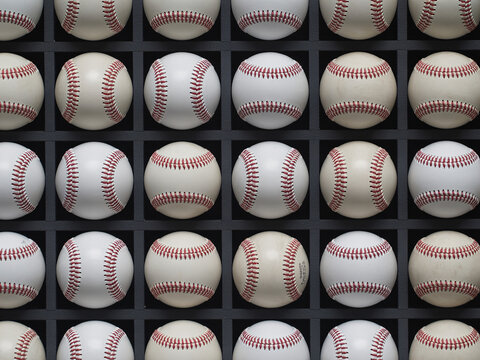 Classic baseballs neatly arranged, ready for the big game, evoking nostalgia and teamwork with iconic stitching and pristine white leather