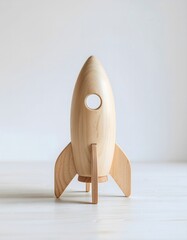 A handcrafted wooden rocket toy made from smooth natural timber