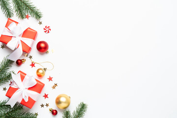 Christmas gift box and holiday decorations at green background.