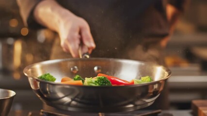 A chef skillfully tossing colorful vegetables, steaming in a stainless steel pan - Powered by Adobe