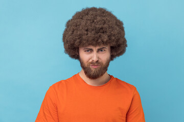 Unhappy man looking at camera with sad facial expression, having problems.