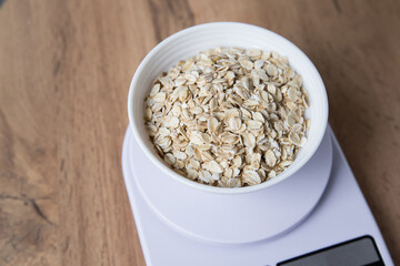 Oatmeal in a bowl on a digital scale
