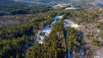 Aerial winter view of evergreen forest and mountains near Keene, New York in the Adirondacks.