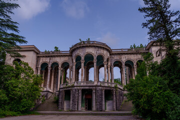 Fototapeta premium Grand abandoned colonnaded palace facade with twin staircases and arches