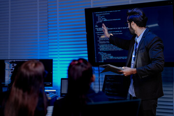 A focused male professional wearing glasses and a headset actively discusses a project gesturing...