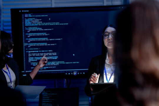 A multi ethnic strategy team two women and one man discusses sustainable ESG innovation. They are using data and AI for future business growth. - Powered by Adobe