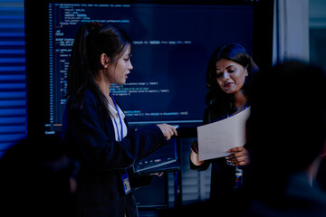 An Indian female leader presents a new digital strategy for future growth. Her team discusses AI innovation, data analytics, and sustainable (ESG) goals in a modern smart office.