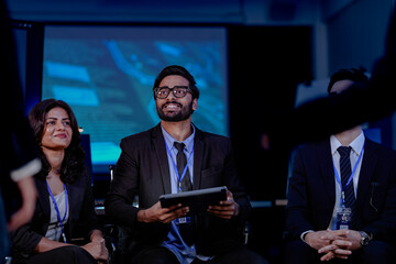 A crisis management team discusses an urgent data security threat. Diverse experts review a rapid response plan to protect customer data and ensure business continuity.