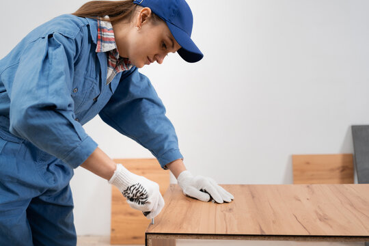 furniture installation process. Young female handyman assembling furniture at home. DIY concept.