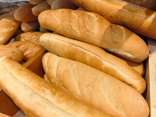 Freshly baked bread rolls piled high in a cozy bakery setting
